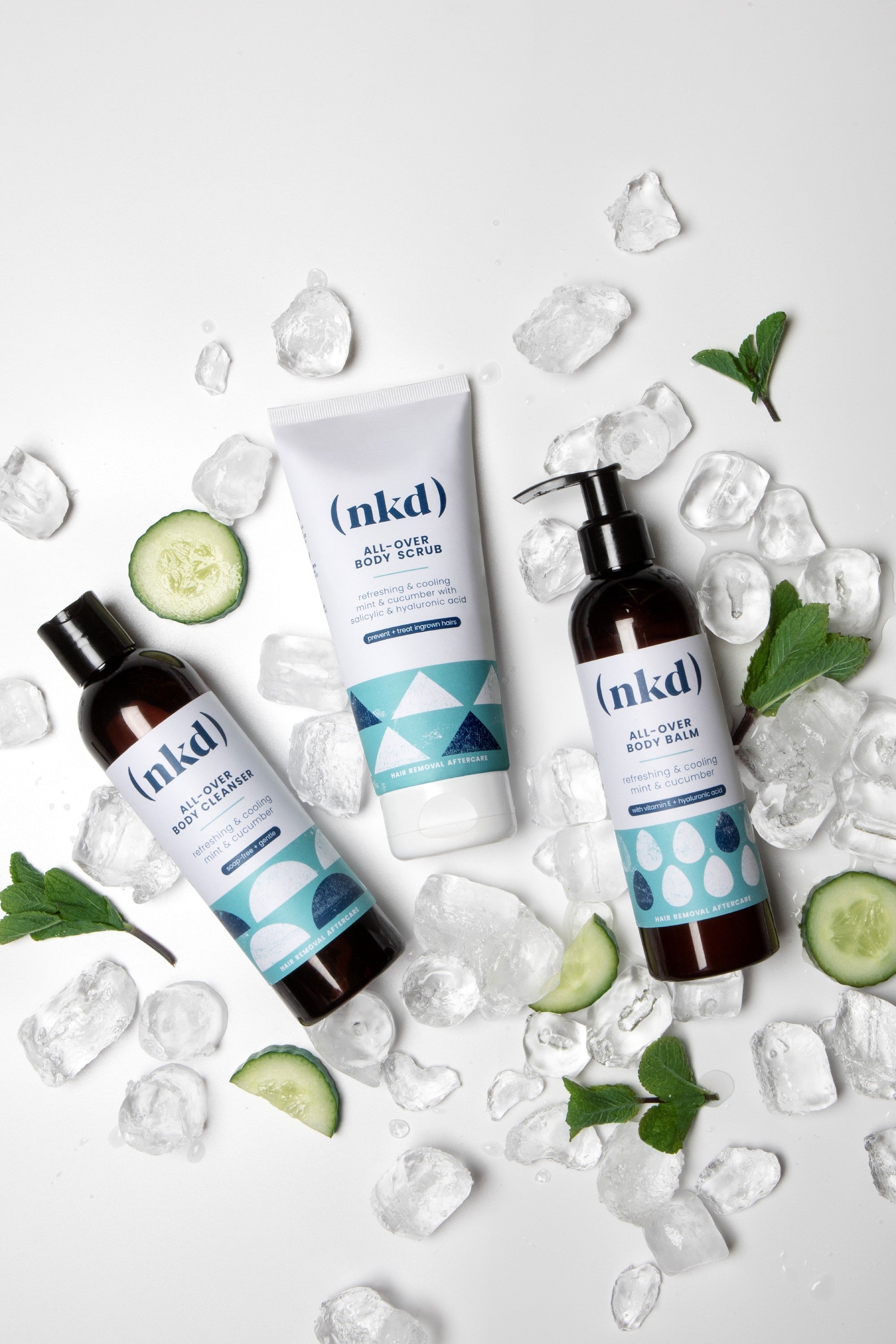 nkd All-Over Body Scrub for gentle exfoliation and soothing sensitive skin. Image featuring nkd's Aftercare product line, including All-Over Body Balm, All-Over Body Cleanser, and All-Over Body Scrub, designed specifically for post-waxing care to hydrate, soothe, and prevent ingrown hairs